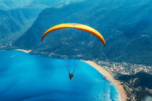 Paragliding In The Sky. Paraglider Tandem Flying Over The Sea With Blue Water, Beach And Mountains In Sunrise. Aerial View Of Paraglider And Blue Lagoon In Oludeniz, Turkey. Extreme Sport. Landscape