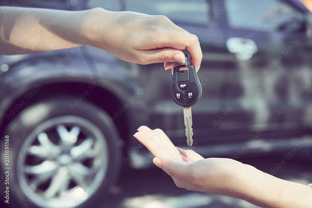 Woman's hand give the car key and blurred background. Stock Photo ...