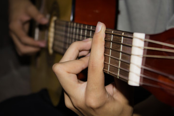 Wall Mural - Close up of young man playing guitar.