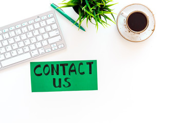 Poster - Frame contact us. Lettering Contact us on office work desk with computer on white background top view copy space