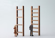 © Hyejin Kang - Miniature men and women standing in front of different ladders. The standard concepts that are discriminatory against men and women in their work.