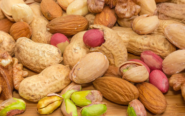 Wall Mural - Background of the various nuts on a wooden surface