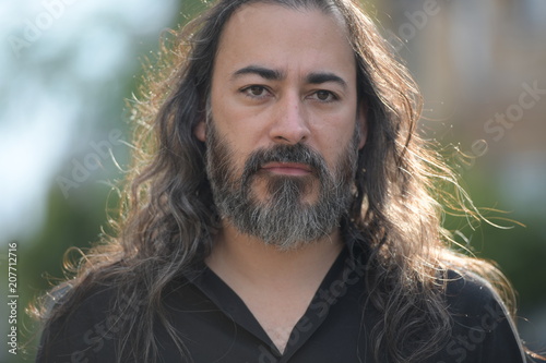Mature Handsome Bearded Multi Ethnic Businessman With Long Hair In