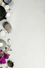 Asian tea set and spa stones on concrete background