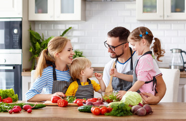 Wall Mural - happy family with children preparing vegetable salad .