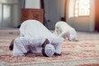 © FS-Stock - Black Muslim man and woman praying in mosque