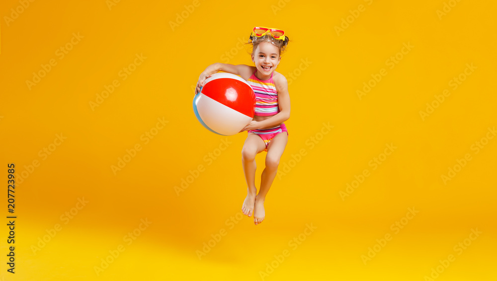 funny happy child  jumping in swimsuit    on colored background - obrazy, fototapety, plakaty 
