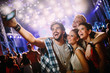 © NDABCREATIVITY - Happy friends taking selfie at music festival