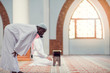© FS-Stock - Two religious muslim man praying together inside the mosque