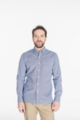 portrait of caucasian bearded man in stylish shirt looking at camera isolated on white