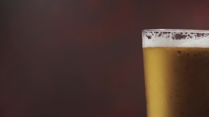 Poster - Beer of glass, rotation 360 degrees. Beautiful red dark background.	