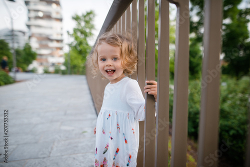 Cute Little Girl With Curly Blonde Hair Wearing Beautiful White