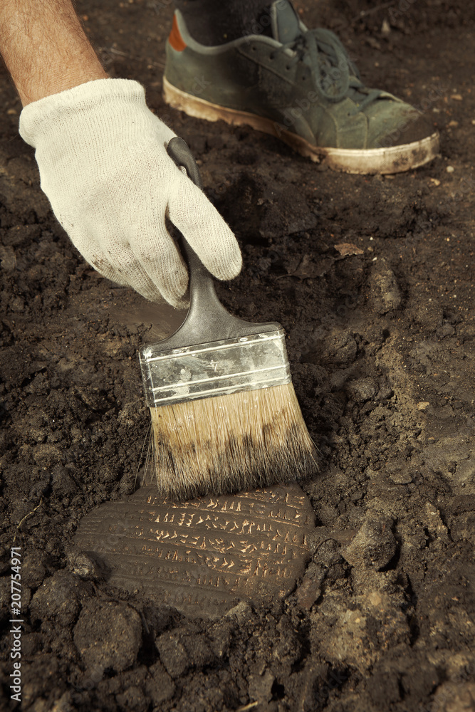 Cuneiform writing of Akkad Empire in brown clay found on summer terrain excavations