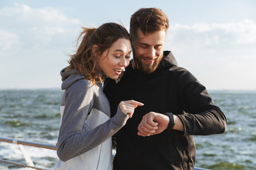 Canvas Print - Happy young sports couple talking