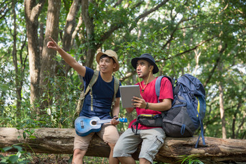 two male hiker using tablet pc