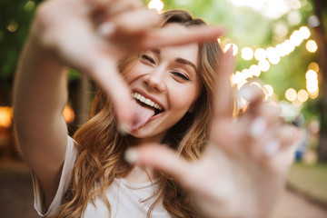 Poster - Close up of joyful young girl showing frame