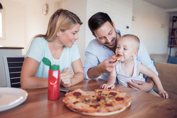 Poster - Happy family eating pizza at home