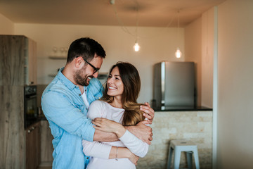 Wall Mural - Couple hugging and looking at each other.