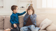 © Prostock-studio - Boy calming down his crying sister at home
