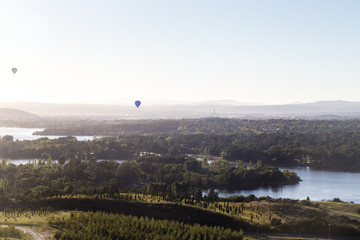 Hot air balooons drifting over Canberra at sunrise