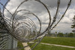 Prison yard fencing with razor wire