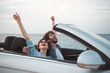 © Yakobchuk Olena - Full of pleasure. Happy positive romantic tourists couple is travelling along road with seascape in background. They are expressing gladness with raised hands while enjoying summer vacation