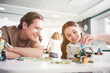 © Yakobchuk Olena - Portrait of cheerful male and happy child creating toy during lesson. Innovation concept
