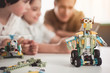 © Yakobchuk Olena - Close up modern robot from constructor. Happy adult and kids looking at it