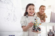 © Yakobchuk Olena - Portrait of happy female child looking at modern toy. Outgoing man using gadget during lesson. Toys of future concept