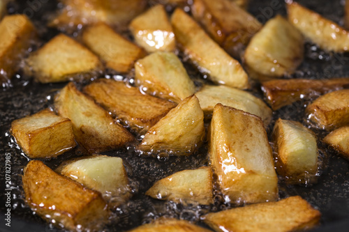 Fotografie, Obraz Frying Fresh Raw chopped Potatoes In Pan With Hot sunflower Oil