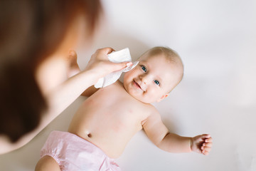 mother wiping baby's face