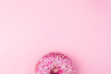 Pink glazed donut on pink pastel background