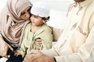 Wall Mural - Muslim grandparents with their grandchild