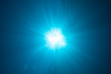 Sunburst And Light Rays In The Deep Blue Ocean Water