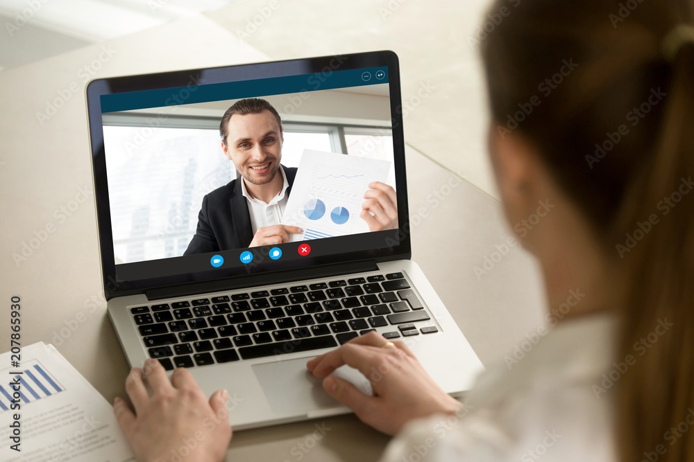 Happy businessman showing positive financial report to remote colleague via video conference call. Project manager proudly shows successful results over webcam application. Closeup view over shoulder. - obrazy, fototapety, plakaty 