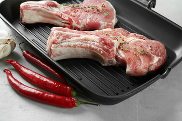 Sticker - Grill pan with fresh raw pork ribs on kitchen table