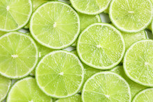Fresh Sliced Ripe Limes As Background, Top View