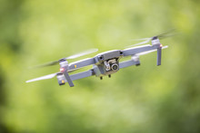 Close-up Quadcopter Drone With Camera Flying In Park
