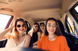 Happy beautiful young women together in car