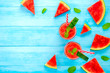 Watermelon juice smoothies in the glasses on light blue wood background