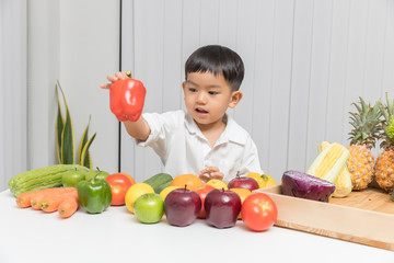 Wall Mural - Healthy and nutrition concept. Kid learning about nutrition to choose how to eat fresh fruits and vegetables.