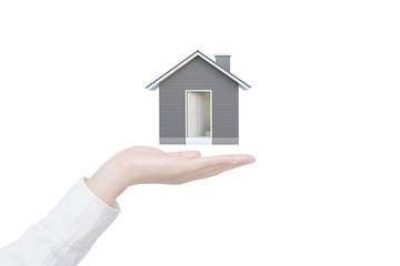 Fototapete - Female hand showing 3D house isolated on white background with clipping path. Image idea of real estate and property concept. House 3D render.