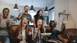 © vadim_key - Cross-cultural group watch sports game on TV. Passionate supporters celebrate goal with drinks. 4K slow motion close up.