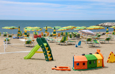 Wall Mural - Playground on the beach with many umbrellas and deck chairs