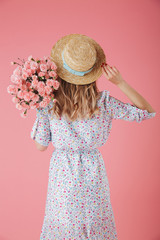 Back view portrait of a pretty young woman in summer dress