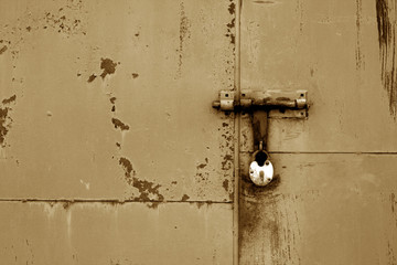 Wall Mural - Old padlock on metal gate in brown color.