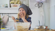 © KONSTANTIN SHISHKIN - Preschool girl baker mixes the dough in a bowl