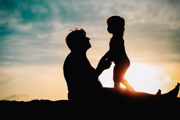 Wall Mural - silhouette of grandmother and little granddaughter play at sunset