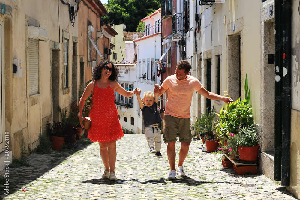 Lisbon Portugal, a young family walks through the old town - obrazy, fototapety, plakaty 