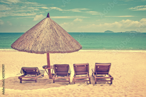 Straw Beach Umbrella And Wooden Reclining Chairs On A Perfect Straw Beach Umbrella And Wooden Reclining Chairs On A Perfect Vintage Process